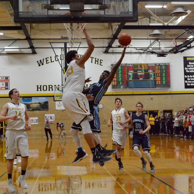 Junior Tyree Spencer taking it to the basket against HSHS senior Barret Benson.