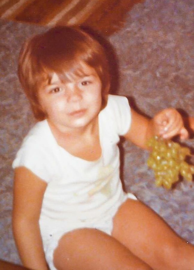 Mrs. Marinakos sporting a nice white romper as a baby.