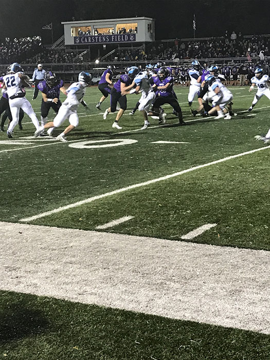 DGS Football running the ball against DGN during the annual crosstown game.