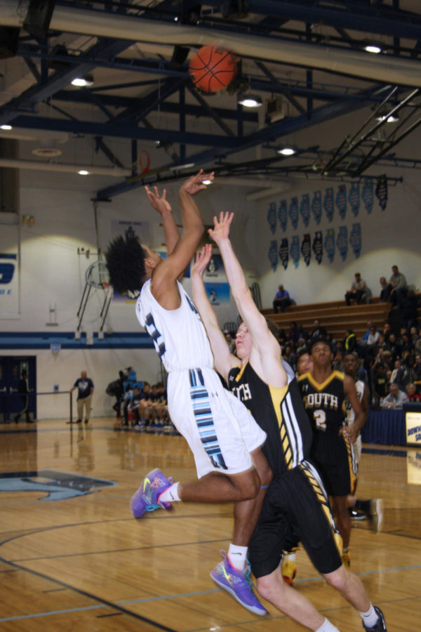 Senior Wesley Hooker goes up for a lay up against his defender.
