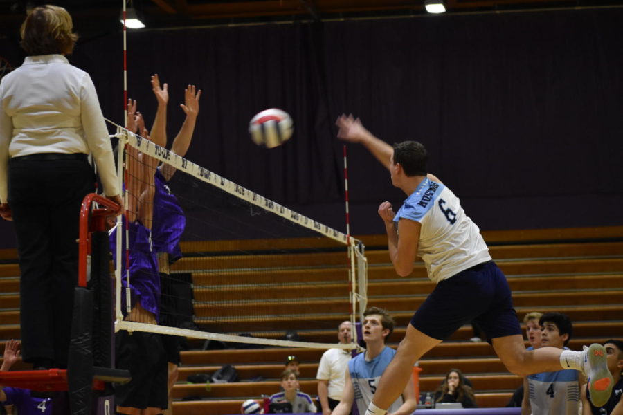 Senior Max Hlavin jumps to spike the ball at the other team.