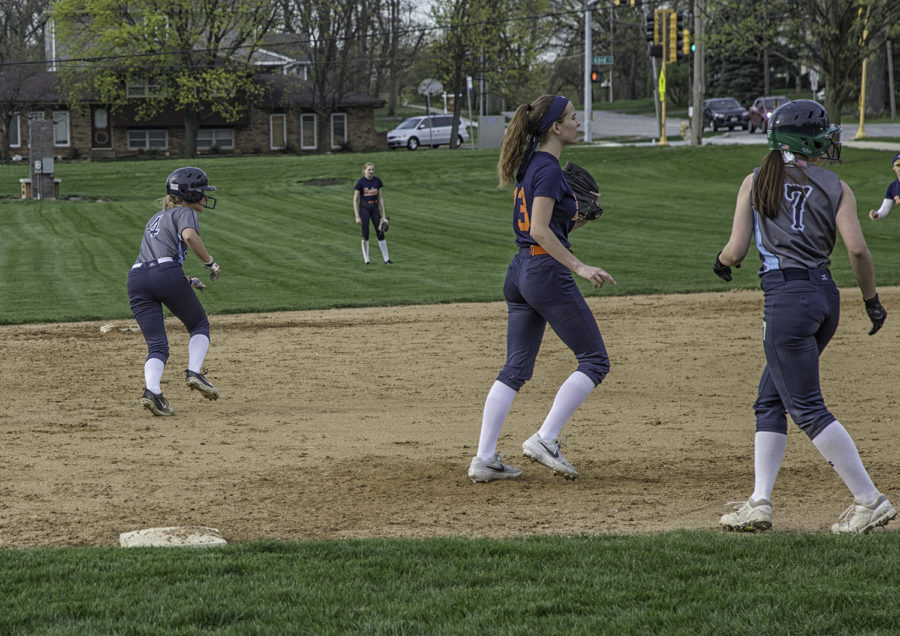 Two members of the team sprinting back to their bases to avoid being out.