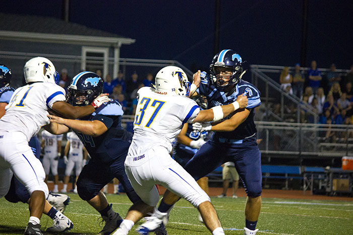 DGS offensive lineman blocking Wheaton North player at a home game.