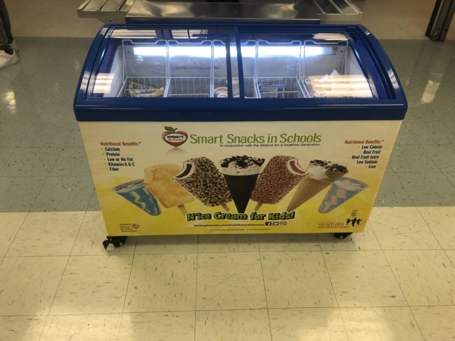 The ice cream freezer located behind the check-out lines in the cafeteria.