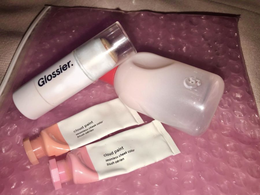 Some+of+my+staple+Glossier+products+with+the+classic+pink+bubble+pouch.