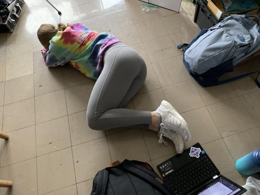 Selective senioritis in action: Sarah Barber lays on the ground during fifth hour, for lack of anything better to do.