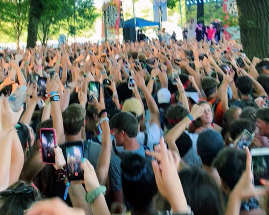 Hundreds of people surround a stage to watch Yung Gravy at Lollapalooza 2019. 