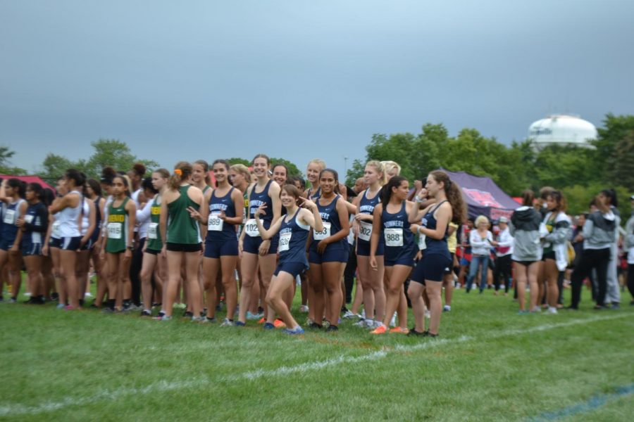 Sophomore Fence Rodi along with other freshmen and sophomore runners pose as they excitedly await their race to begin.