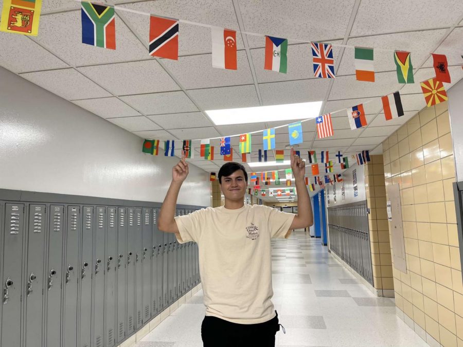 Papavero poses near his language classroom where he practices speaking French, his fourth language, almost everyday. 
