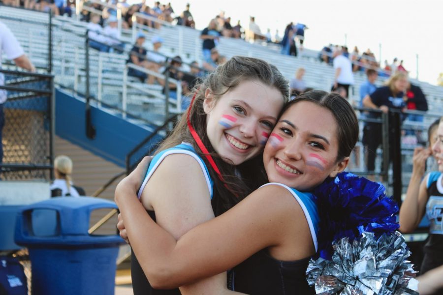 Junior Stephanie Gaspari and senior Adreana Duarte pose for a photo before the start of the game. Gaspari is glad to be performing again and enjoys,“being surrounded by people that love to show their school spirit!”