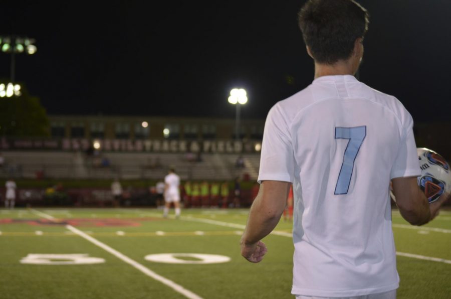 Senior Giovanni Torrijos looks sharply out onto the field, keeping the ball steady in his hands. Before the throw-in, he contemplates where the ball would be played best. 