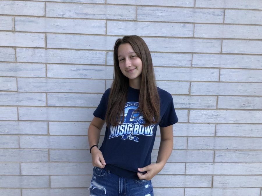 Liv Balicki, third year member of the Marching Mustangs, wears her 2019 Music Bowl shirt to show support for this years upcoming Music Bowl.
