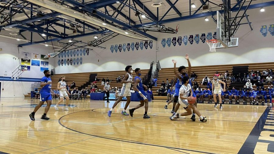 Sophomore Richard Gasmen dodges a Proviso East point guard to successfully score two points. 