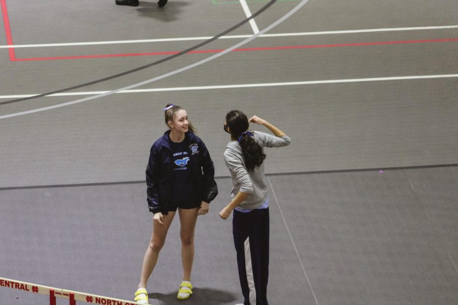 Seniors Gabrielle Hewawissa and Sara Homberg encourage each other before they race. Both are members of the sprinting team.