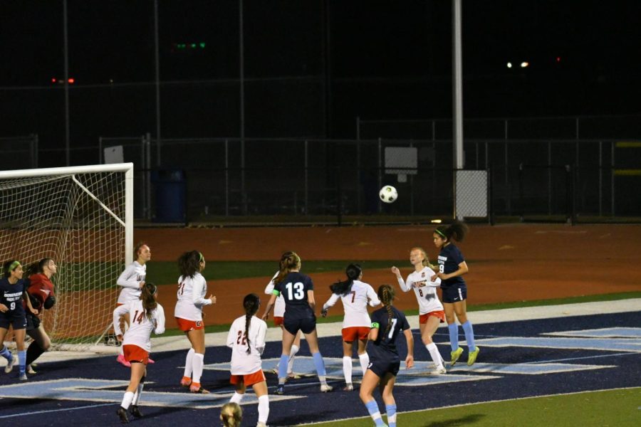 Junior Teyani Sharkey headbutts the ball in an attempt to score, but it goes over the net.