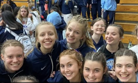 The girls track team poses for a celebratory photo after winning the WSC Gold Indoor Conference Championship, all fashioning their braided hair.