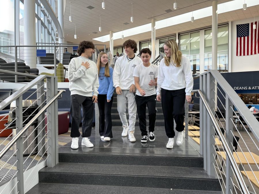 The DGS members of Future Legacies laugh as they walk around school wearing their team sweatshirts