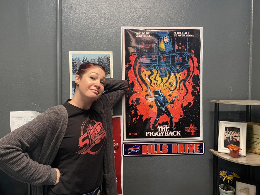 English teacher Tiffany Rubin celebrates the black and red spirit day in front of her Stranger Things poster.
