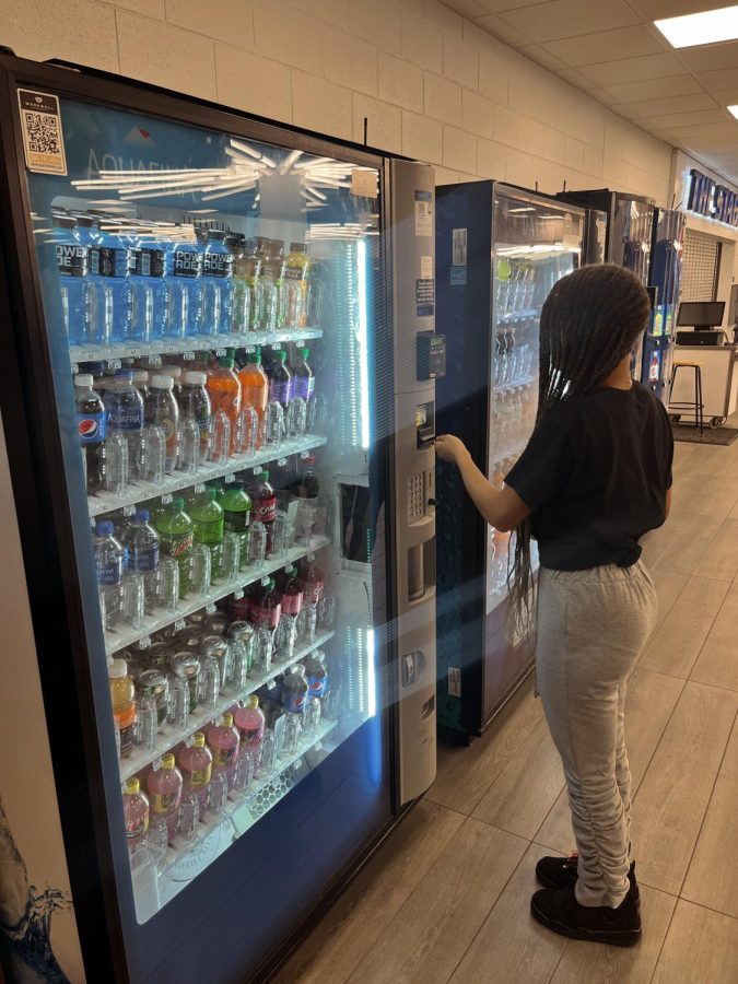 Students buy beverages from the vending machine to fuel their caffeine addiction. 