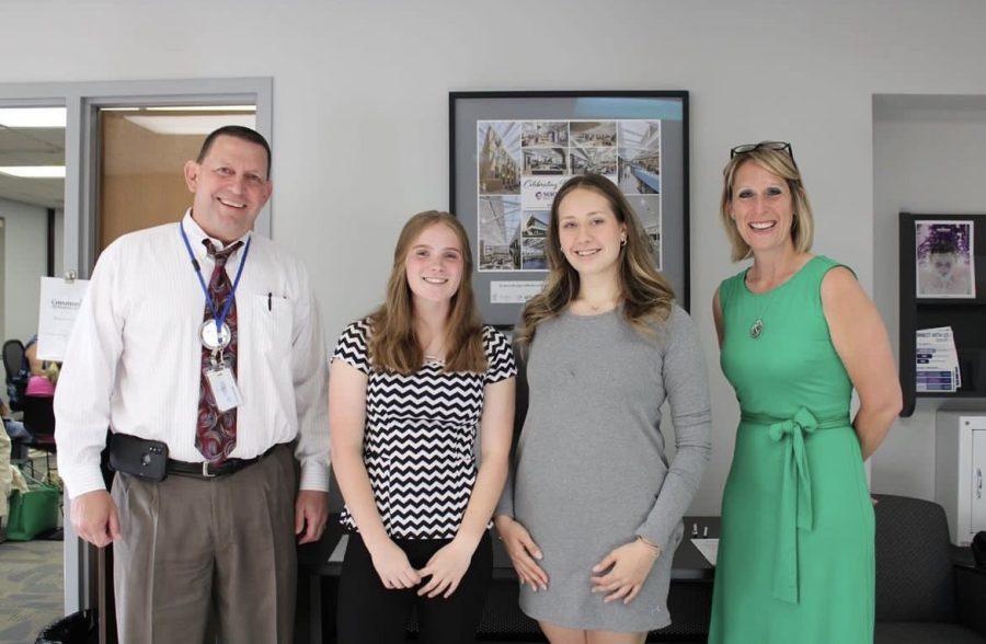 Kaitlyn Vincent (middle left) poses for picture with past principal Edward Schwartz (Left), DGN student representative Luka Paulau (middle right) and DGN principal Courtney Dement.