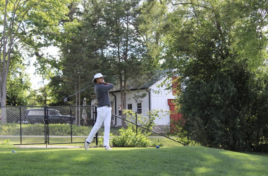Senior Zack Deplaris watches as he hits yet another ball down the fairway