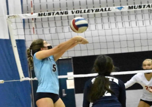 Before her injury, junior Taylor Mitchell bumps the ball into the air during a game against Montini Catholic High School.