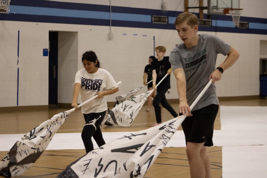 Lucas Edie, Tyler Havle and Suleyka Mejia practice their routine for their upcoming competition on March 12 at Naperville North High School.