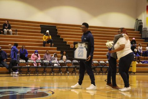 This photo was taken at senior night where Eugene received his jersey with his name on it.