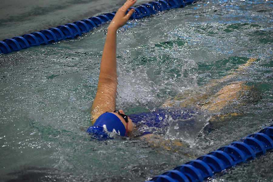 Sophomore Natalia Myers races to the end of the pool while doing the backstroke.