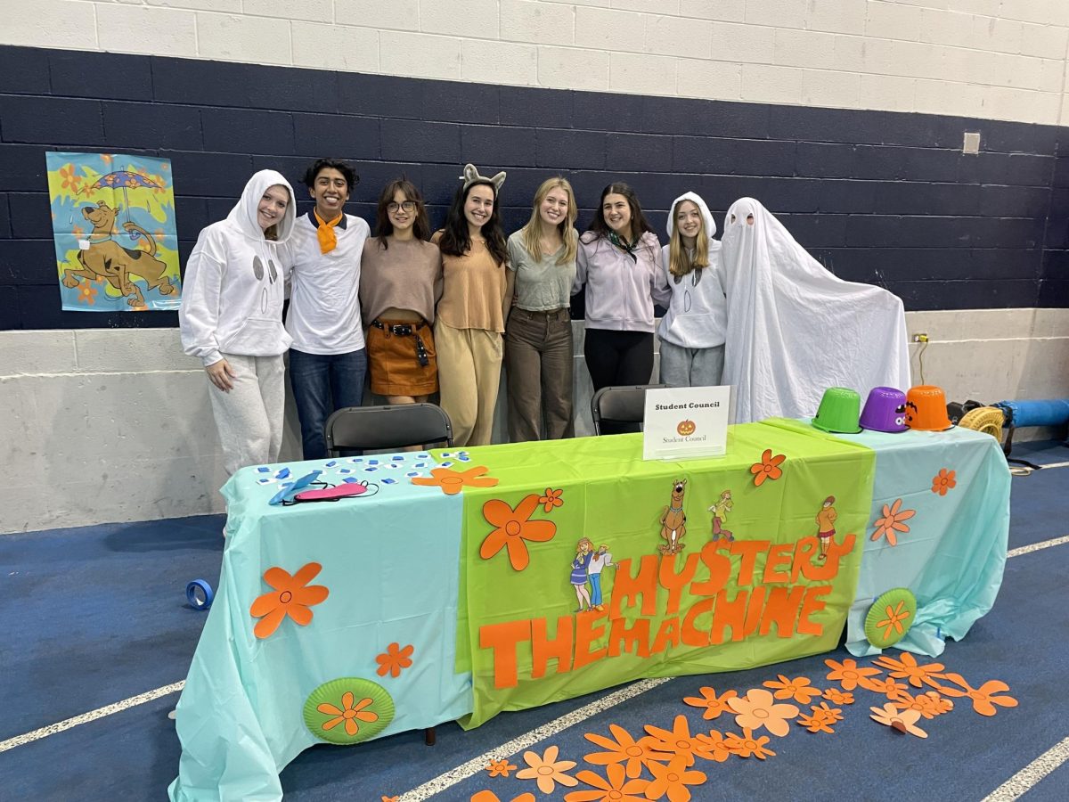 The theme of Student Council’s table is Scooby Doo, decorated as the mystery machine. Since the fair was moved indoors, Student Council members changed their car decorations to decorate the table inside the field house. 
