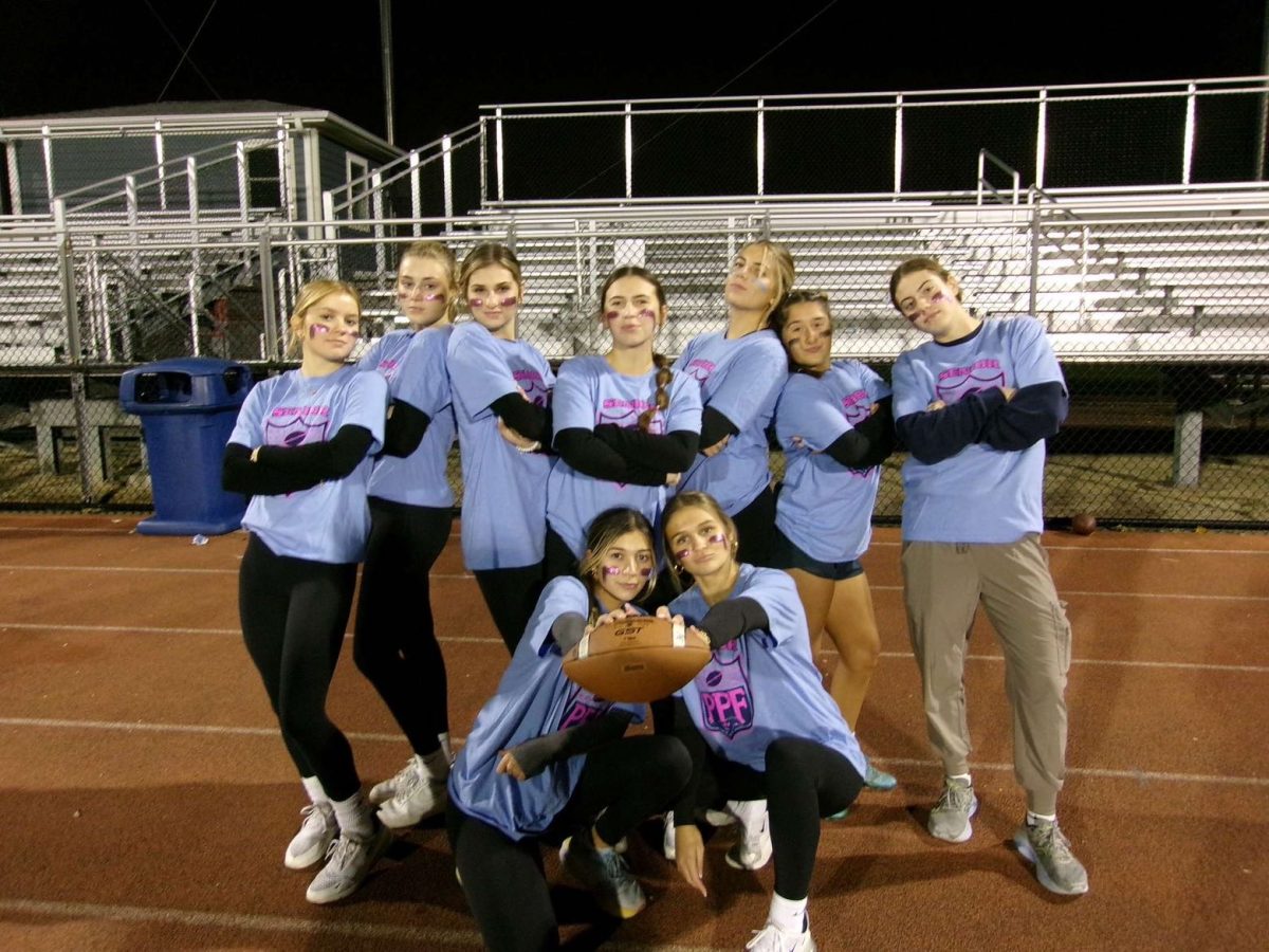Maeve Galvan poses with her close friends after the seniors win Powder Puff football. 