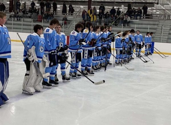  The varsity hockey team lines up for the national anthem before playing the Plainfield Predators. 