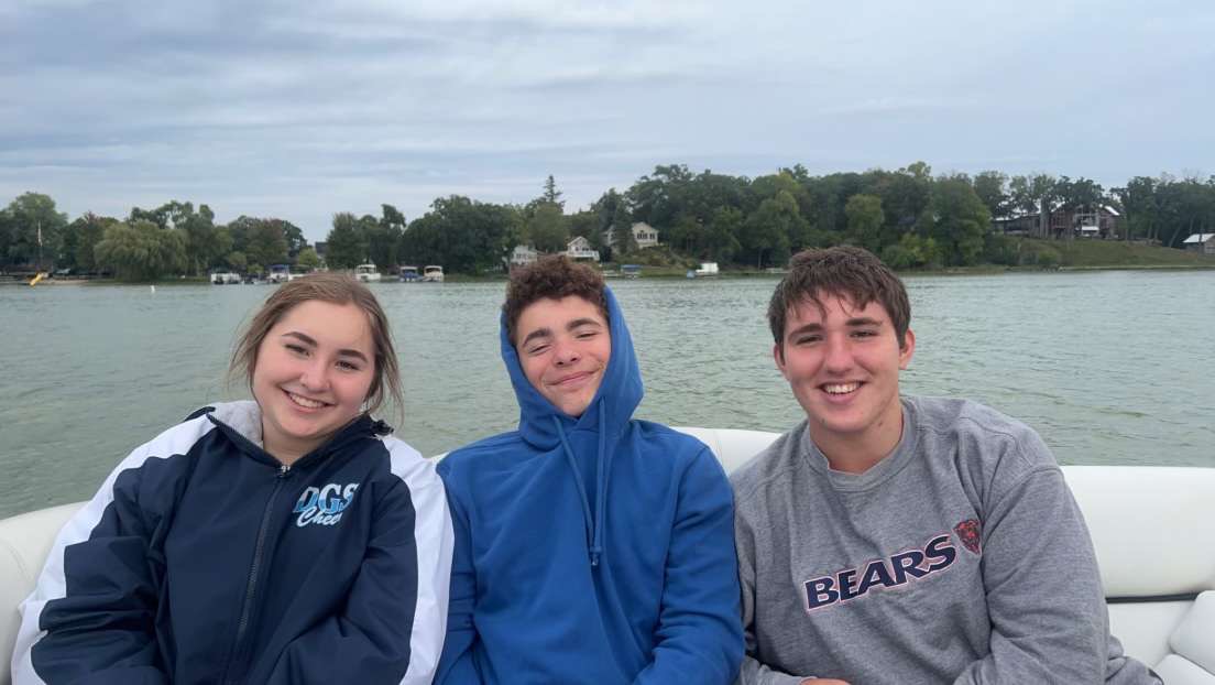 Jonny Klaeren, Danny Klaeren and Eleni Klaeren taking a picture together on the lake. 