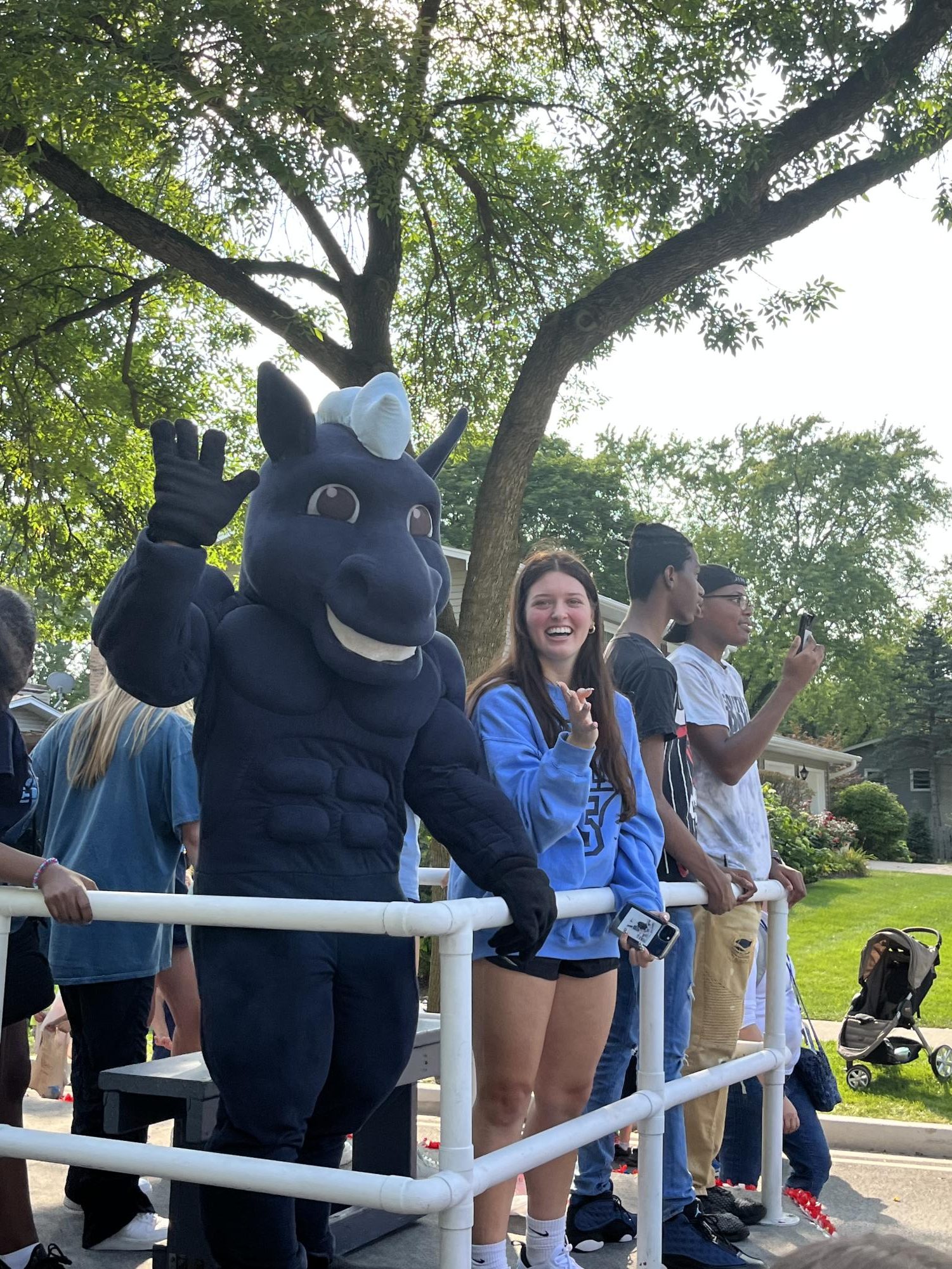 Makenas waves at the crowd as a form of communication during the 2022-23 homecoming parade. 