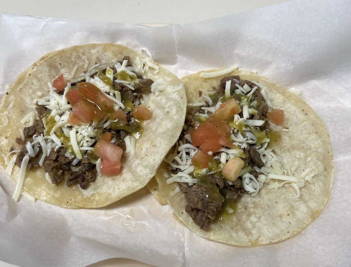 Taco Express steak tacos feature two tortillas, steak, cheese and tomatoes topped with fresh green salsa.