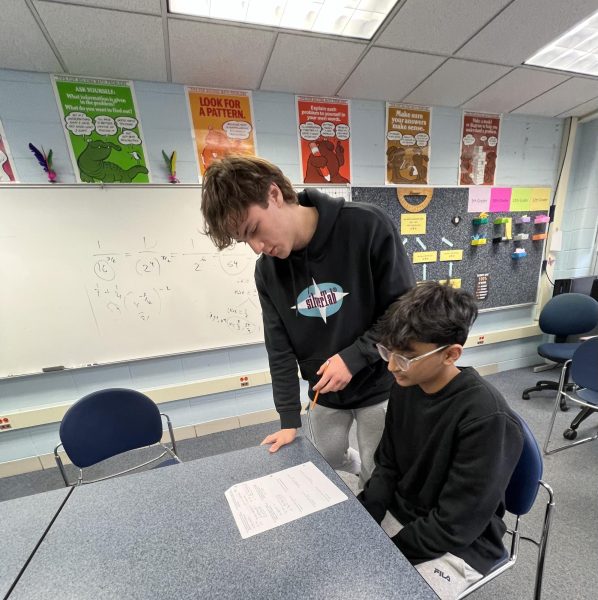 Students that work in the math resource center sit at tables specific to their math classes while getting help from peers. 