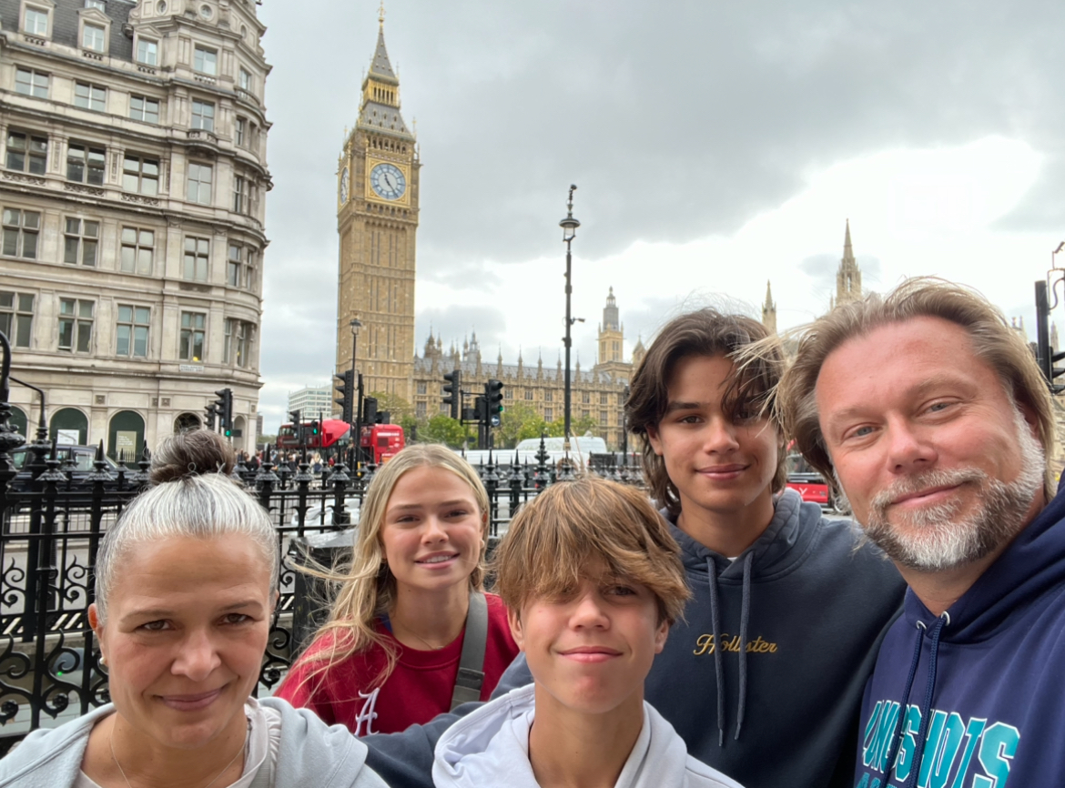 My family posing for a selfie in front of Big Ben. 