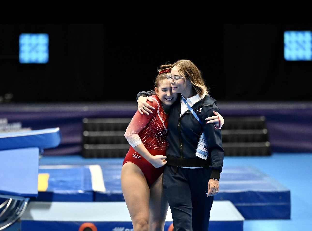Kent gets support from USA Gymnastics Double Mini National Team head coach Chelsea Rainer after placing sixth in the 37th FIG Trampoline Gymnastics World Championships in Birmingham, GBR