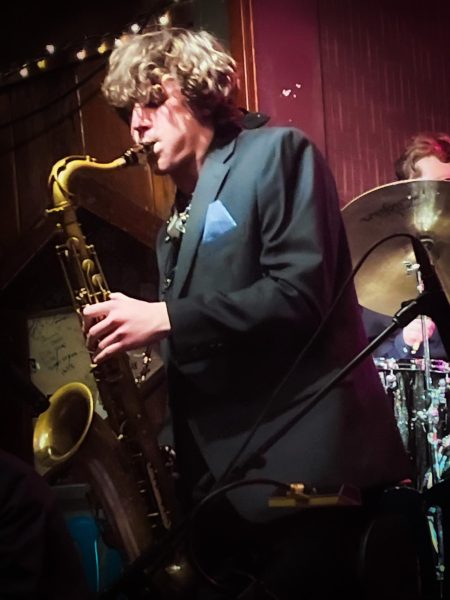 Senior Lucas Ciocan performs skillfully on his tenor saxophone during a jazz concert.