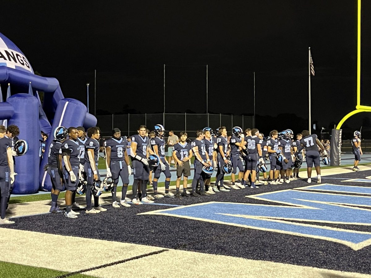 The varsity football team lines up in the end-zone before they kickoff their first game of the season against Metea Valley High School. 