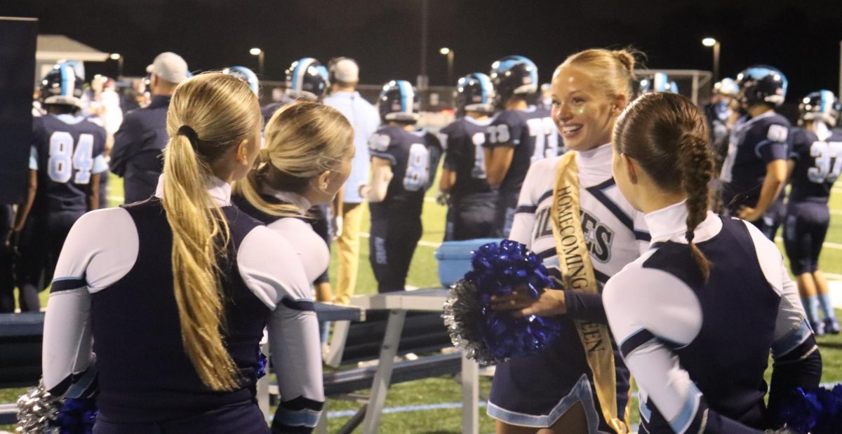 Joined by friends, senior Estella Rizzo sports homecoming queen sash during the game. Stretching from freshman to senior, Fillies maintain close relationships that allow them to grow as a team. 