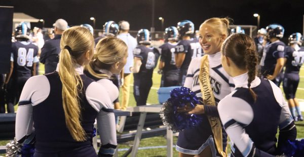 Joined by friends, senior Estella Rizzo sports homecoming queen sash during the game. Stretching from freshman to senior, Fillies maintain close relationships that allow them to grow as a team. 