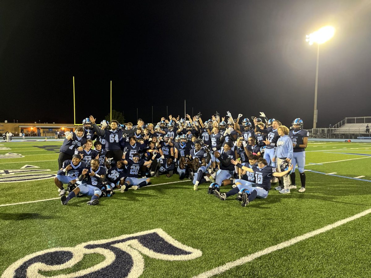 The team celebrates their victory over Hinsdale South by presenting the cannon that will stay at DGS for another year. 