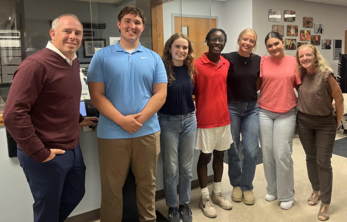 DGS principle Arwen Lyp and physical education teacher Nate Terry stand with seniors Johnny Klaeren, Becca Snouffer, Gavenson Bayer, Estella Rizzo and Ariella Urias outside of the Oct. 7 Board of Education meeting. 