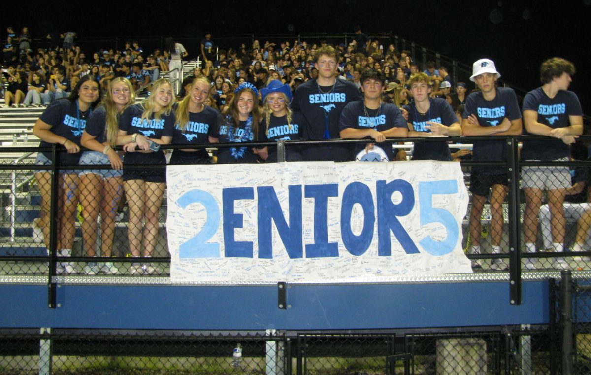 Senior Superfans smile full of excitement as the first FNL of the school year begins. The theme “Blue-out” coincides with the varsity team’s senior night. The stands are packed full of upperclassmen trying to enjoy their last moments as high school students.