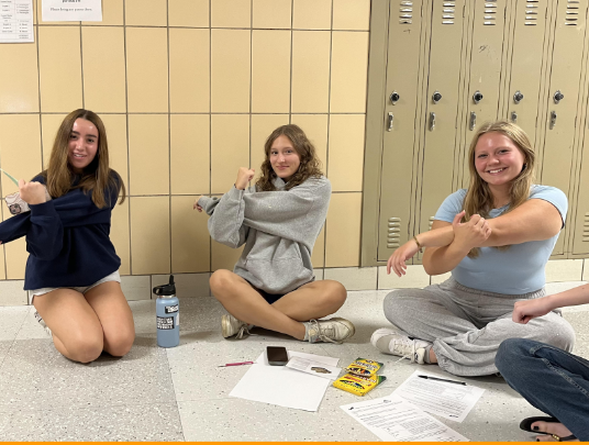 Senior Gabbi Robertson (left) guides students through a set of stretches.
