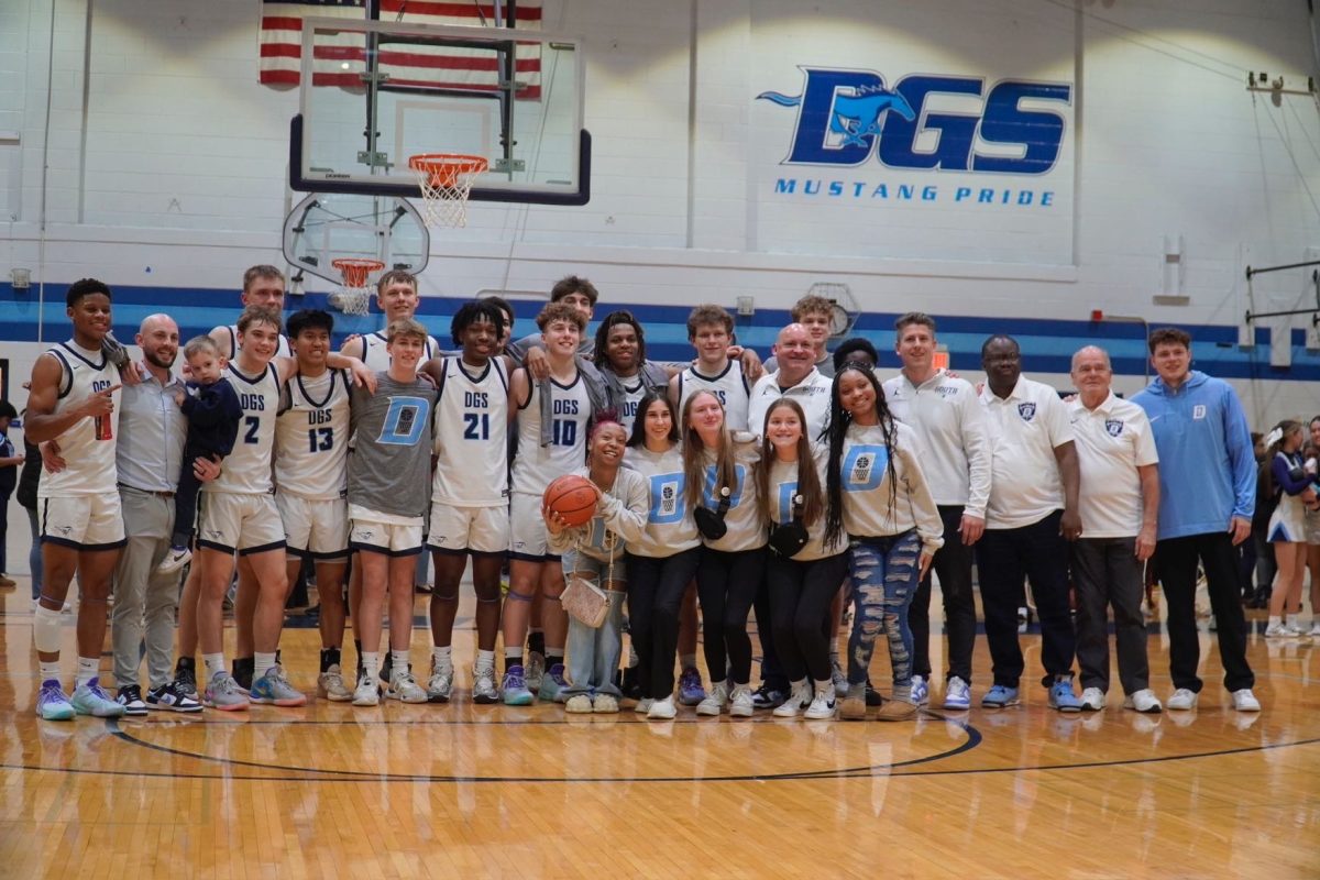 The 2024 varsity boys basketball team gets together after senior night. 