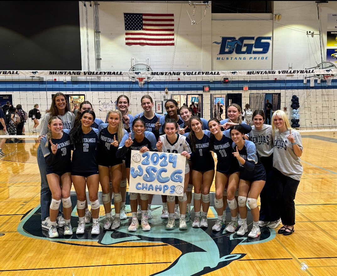 Varsity poses on the court after defeating Hinsdale South to secure the conference title.