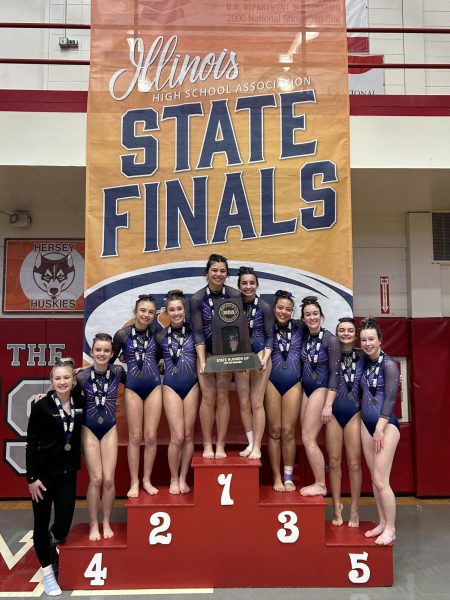 Trostangs receive second place trophy at the IHSA Girls Gymnastics state meet.