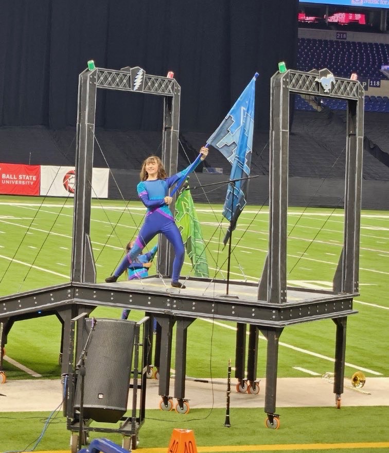 Riley Flood performing on the bridge during the color guard’s final performance at Lucas Oil Stadium